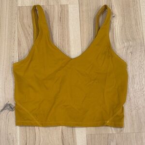 Women’s Lululemon mustard colored crop top